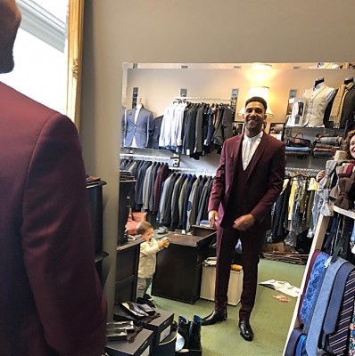 Jay admiring finished red suit - tailor
