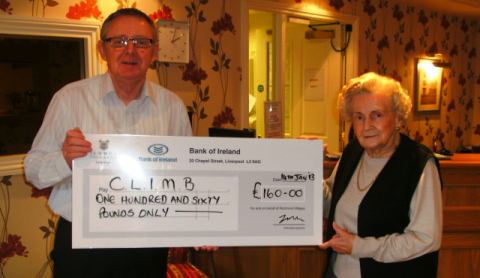 Richmond Village present cheque to CLIMB charity