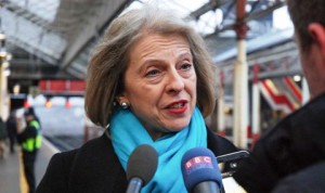 Theresa May MP, quizzed by reporters at Crewe station