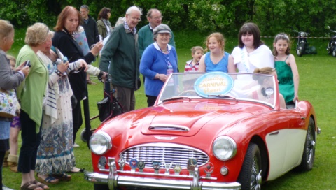 Carnival Queen Amelia Steele (backseat centre) and Princesses on parade in Austin-Healey 3000