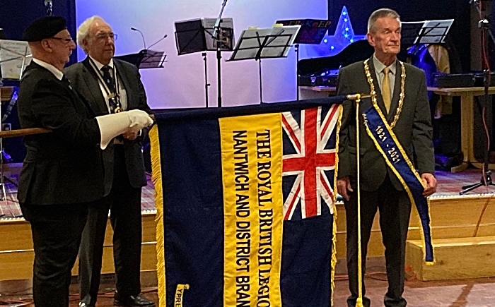 Nantwich Town Mayor Cllr Stuart Bostock attaches the 100 year ribbon to the Branch Standard, assisted by the Branch President John Dwyer (1)