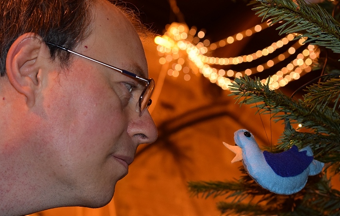 Publicity photo for Acton Christmas Tree Festival 2021 - visitor Andrew Lyon views a Christmas tree decoration