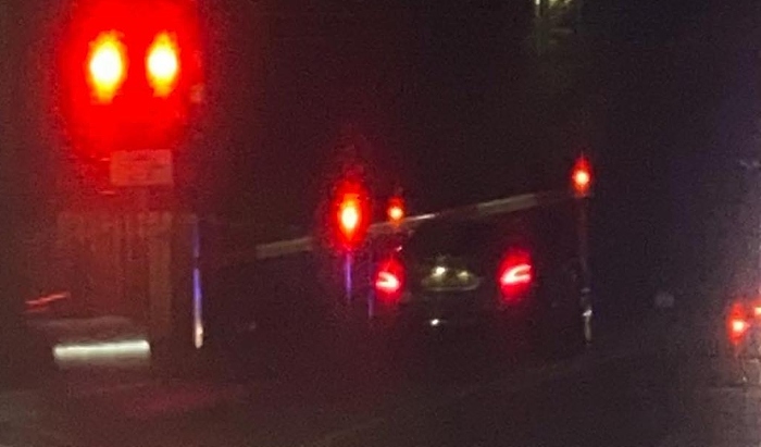 car under level crossing barrier London Road