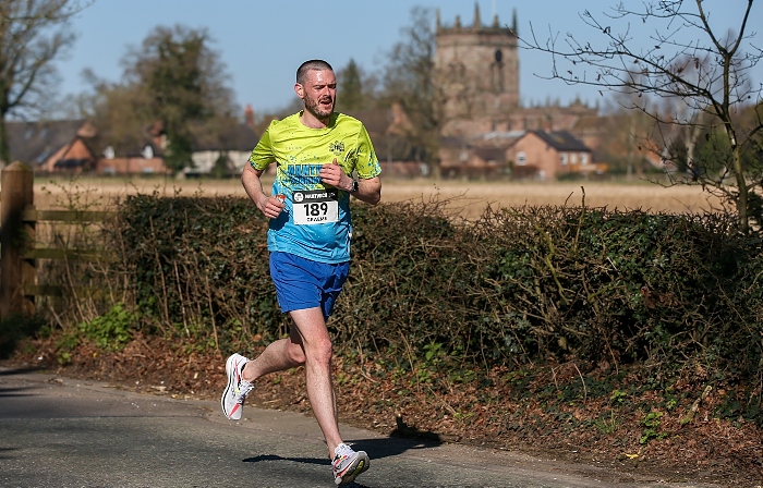 Nantwich 10K road race - Top local finisher - Graeme Rathbone (Nantwich Running Club) with St Mary's Acton in the background (1)