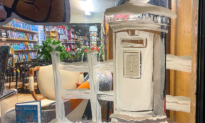 window of Nantwich Bookshop on High Street - winter scene with Post Box and Robin