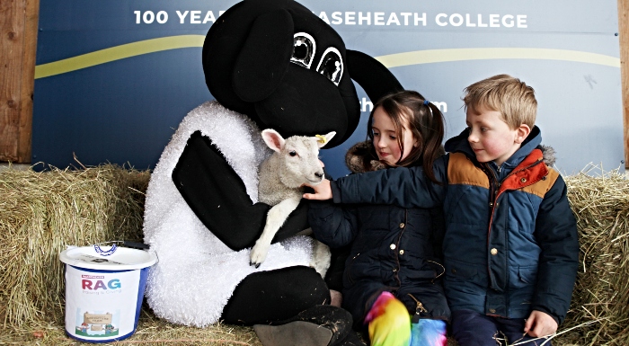 Ayla, 8, and Freddie, 6, from Somerford meet RAG mascot 'Gareth' and a lamb