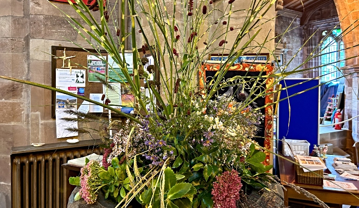 A flower arrangement on the font - harvest acton