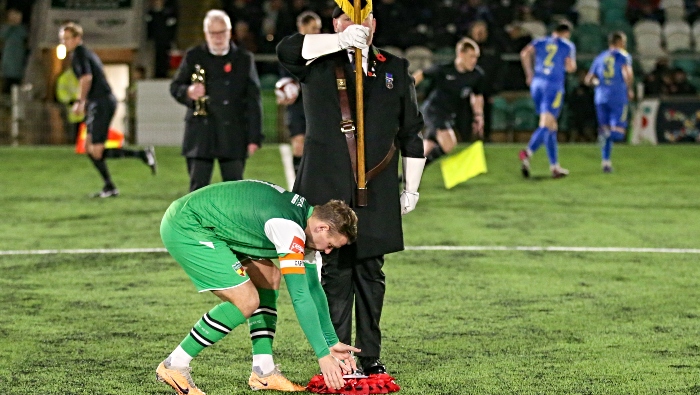 Nantwich Town FC captain Steven Hewitt lays a poppy wreath in the centre of the pitch (1)