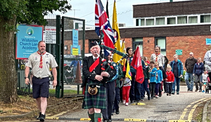 Parade leaves school led by Scottish piper Reg Flower (1)