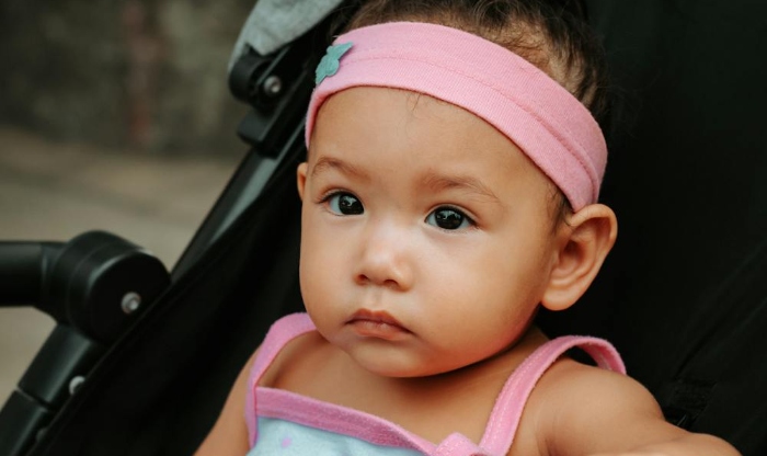 child in pushchair - free to use by https___www.pexels.com_photo_child-in-stroller-12935861_