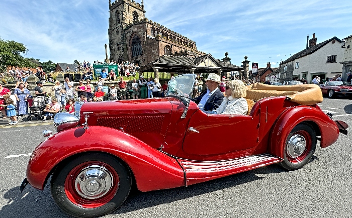 A vehicle in the parade passes St James' Church in Audlem (1)