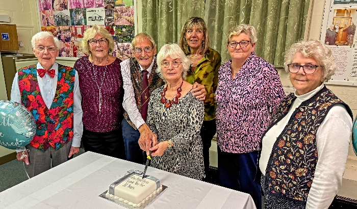 Colin and Christine Wood (centre) cut their 30 years of service thank you cake with friends (1)