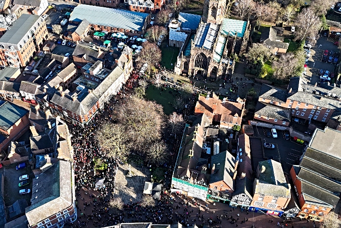 Aerial view of troops and visitors in town centre