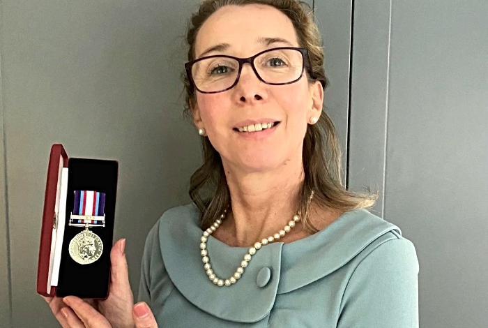 Veronique displays Humanitarian Medal