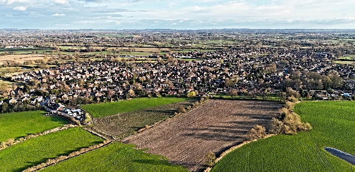 aerial view of land in foreground being eyed by Redrow Homes