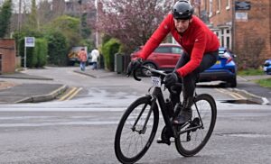 Cheshire Cat Sportive cyclist on Millstone Lane in Nantwich with St Mary's Church in the background (1)