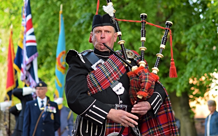 A lone piper leads the parade along Churchyardside (2)