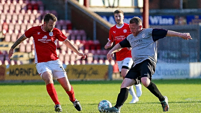 Opposition players eye the ball (1)