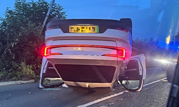 Polestar car flipped on roof on A51 in Alpraham_censored