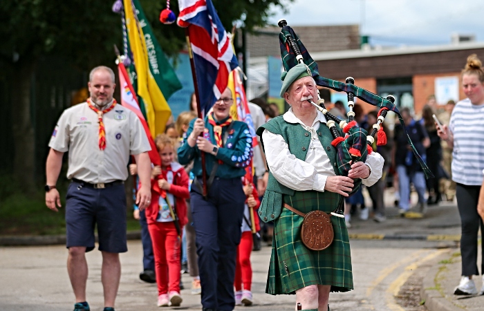 Scottish piper Reg Flower leads the parade
