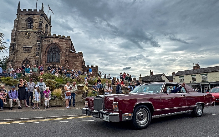A Lincoln Continental car in the parade passes St James' Church in Audlem (1)