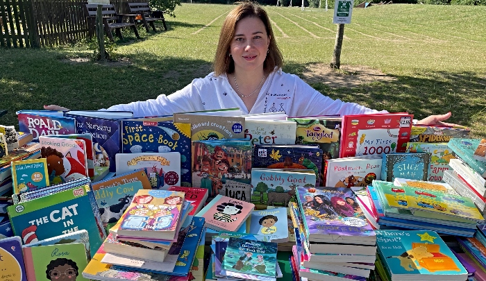 Kateryna with books collected by Pear Tree pupils