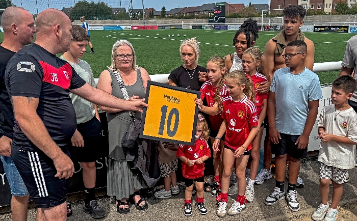 John Bebbington (left), the Square One Assistant Manager, presents framed No.10 Square One FC shirt to Chesters family (1)