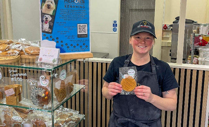 Shop staff member Katie with a HerOES Rehoming charity dog biscuit (1)