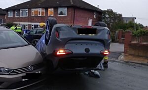 Car crashes into vehicles and lands on roof in Nantwich street