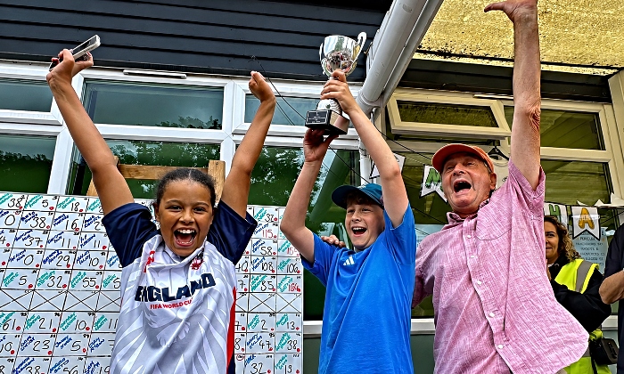 Sienna Beavers, Archie Clarke and Peter Clarke lift the winning trophy (1)
