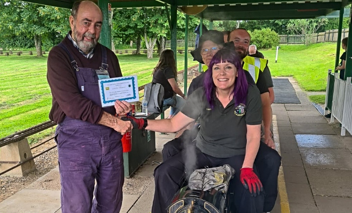 Society Chairman Ian Murray presents to Laura Brown (sitting) (1)