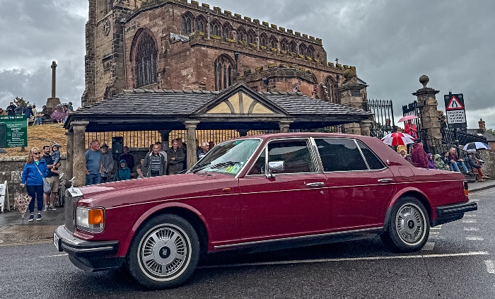 A Rolls-Royce car in the parade passes St James' Church in Audlem (1)