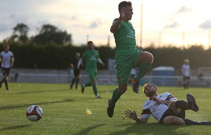 A Nantwich player rides a tackle