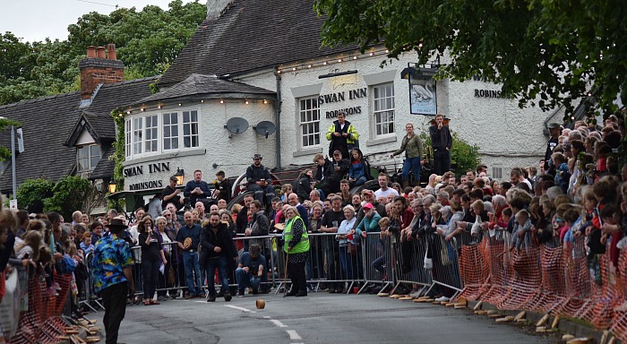A competitor in the Adult race rolls outside the Swan Inn