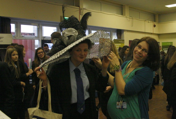 Alice Tongue, with the assistance of Vicky Venn from Reaseheath College tries on the 'My Fair Lady' hat made from floristry wire especially for the Chelsea Flower Show