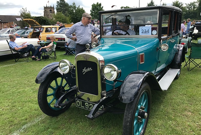 An Austin Heavy owner enjoys a chat on Audlem Playing Field after the parade