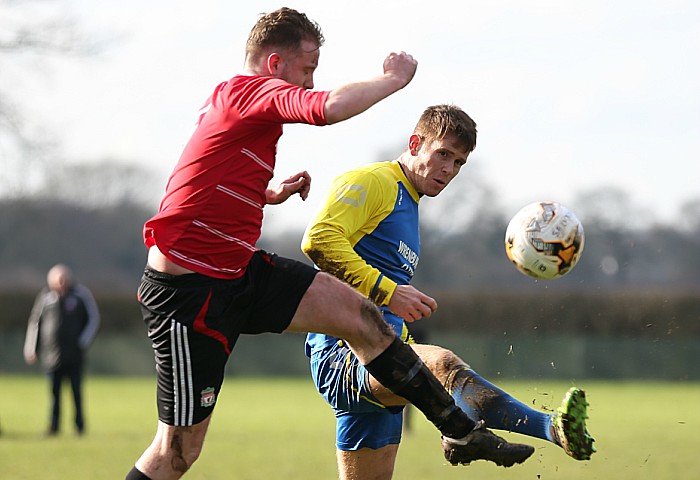 Both players challenge for the ball