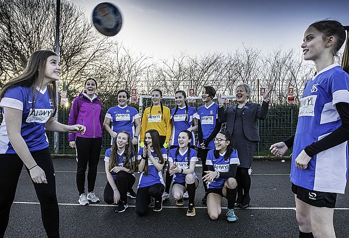 Brine Leas School pupils Rebecca Hughes (front left) and Eleanor Evans (front right) test out their new football kits courtesy of Anwyl Homes