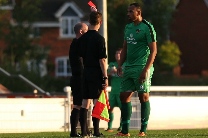 Clayton McDonald receives a red card against Newcastle Town