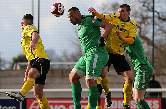 Clayton McDonald wins the ball with a header