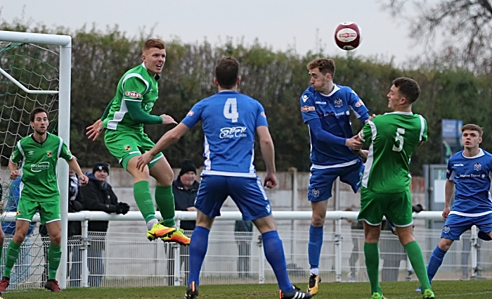 Danny Glover heads the ball clear (1)