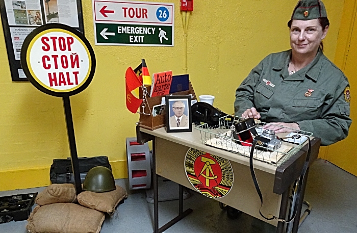 East German border guard prepares to stamp papers (1)
