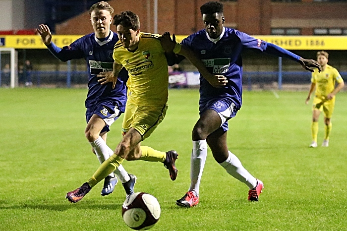 First-half - Matty Devine eyes the ball under pressure (1) v Leek Town