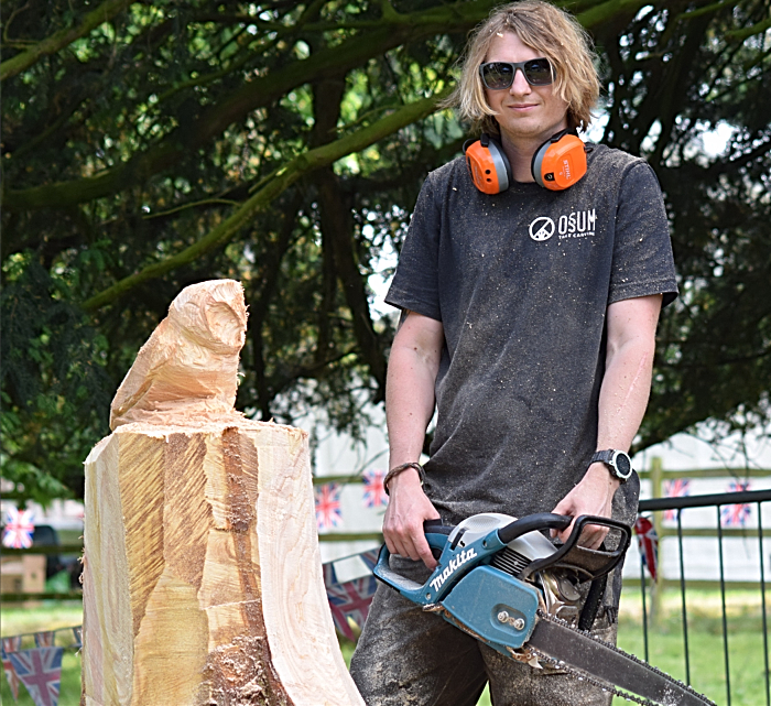 Former Reaseheath College student Paul Edwards poses with his chainsaw sculpture