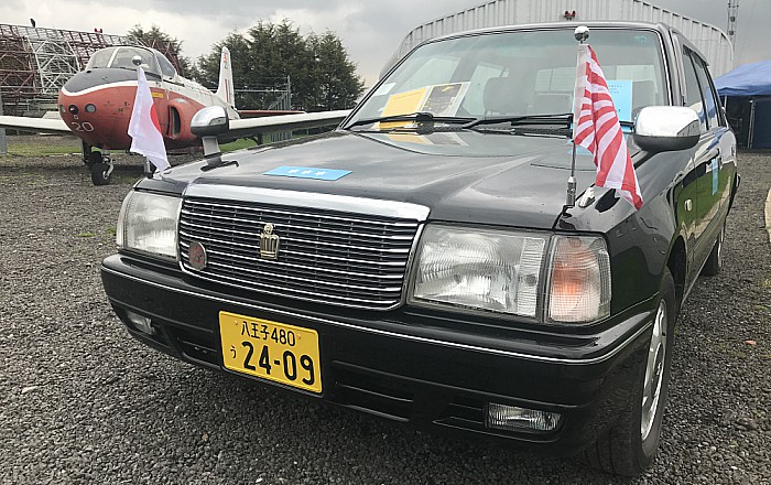 Japanese Crown Sedan car and a British military aircraft