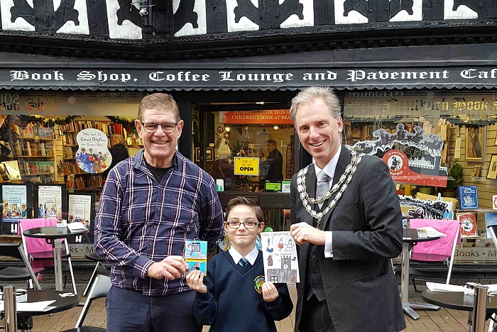 Jaymes, winner of Christmas Card competition, with Mayor Andrew Martin and Bookshop owner Steve Lawson