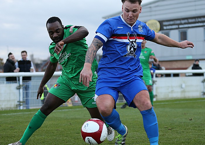 Joe Mwasile challenges for the ball