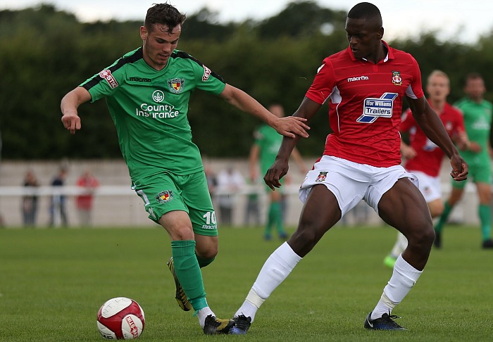 Jordan Davies holds off a Wrexham player