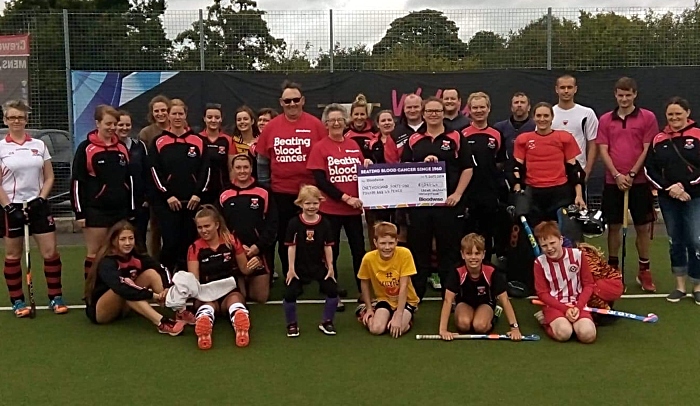 Katie Gibbs-Blythe from Crewe Vagrants Hockey Club presents the cheque to Liz and Mike Boffey from Bloodwise