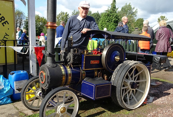 Les Riley proudly poses with his steam traction engine Maud